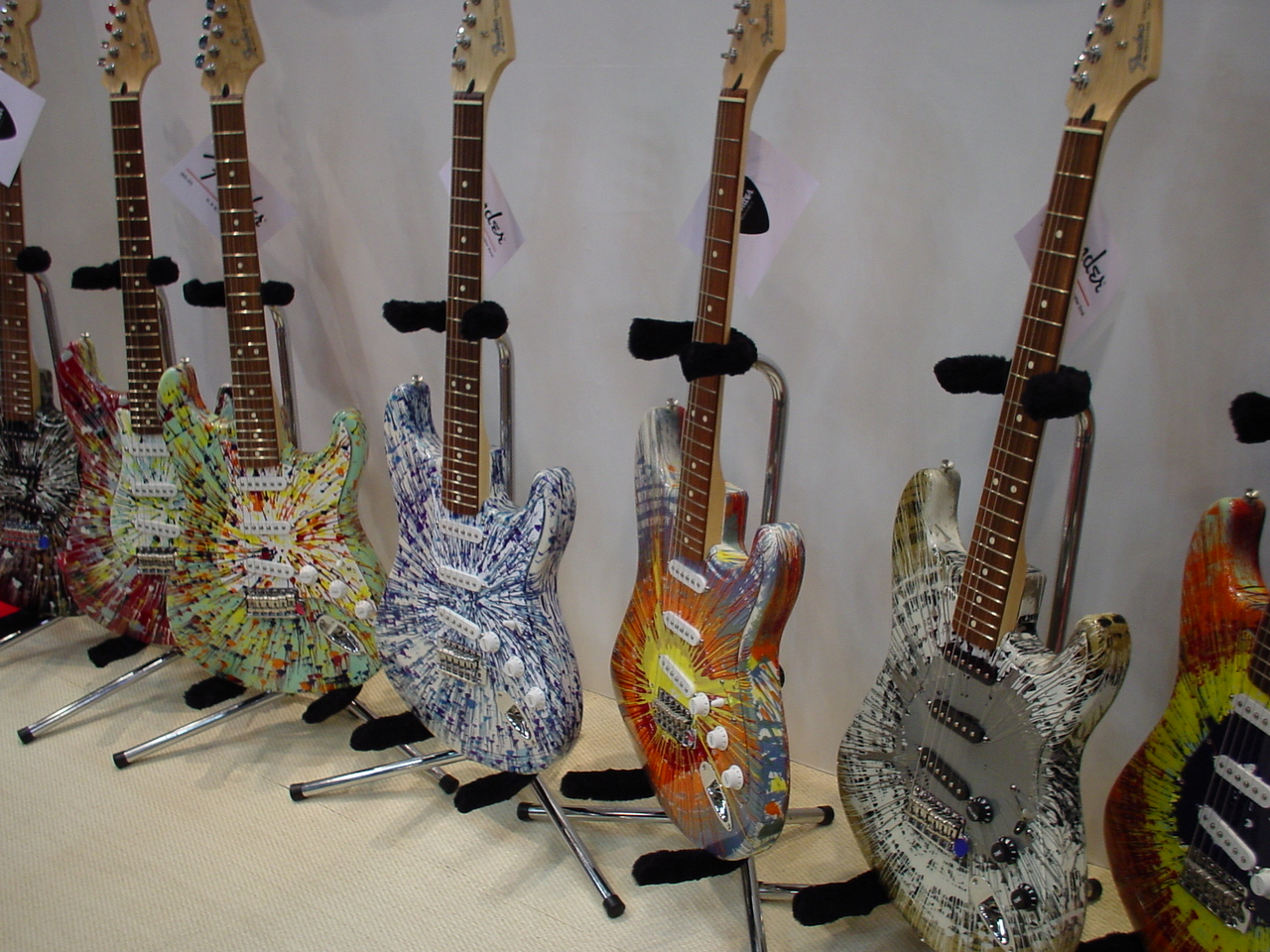 several guitars are lined up against the wall