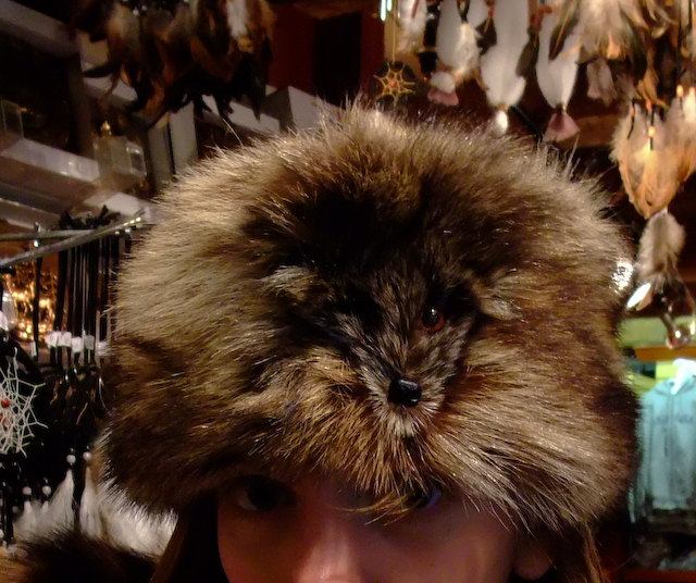 a woman wearing a furry cap with spikes