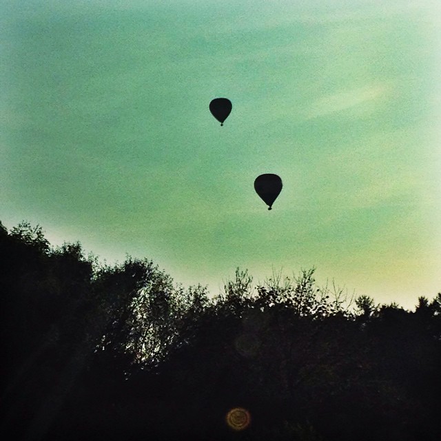 two  air balloons flying in the sky