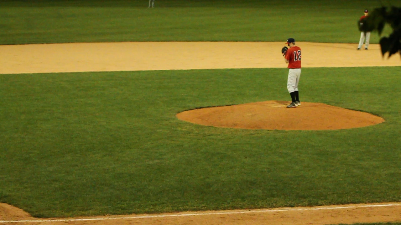 the pitcher is standing on the mound on a baseball field