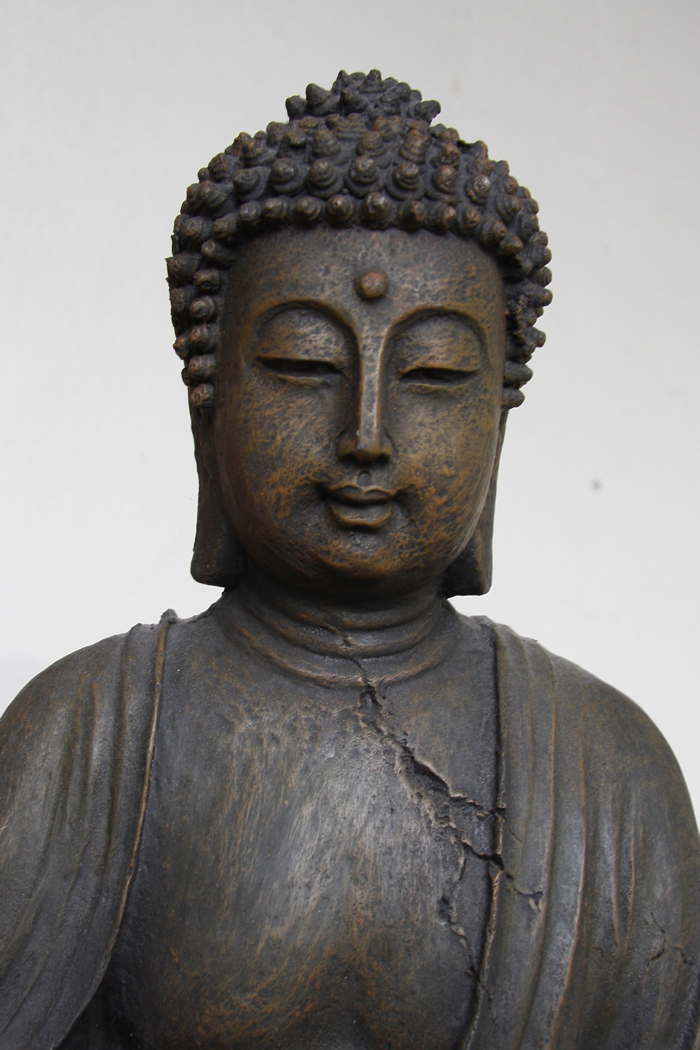 large statue of buddha with eye glasses on head