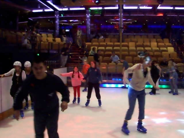 a group of people in line skating on ice
