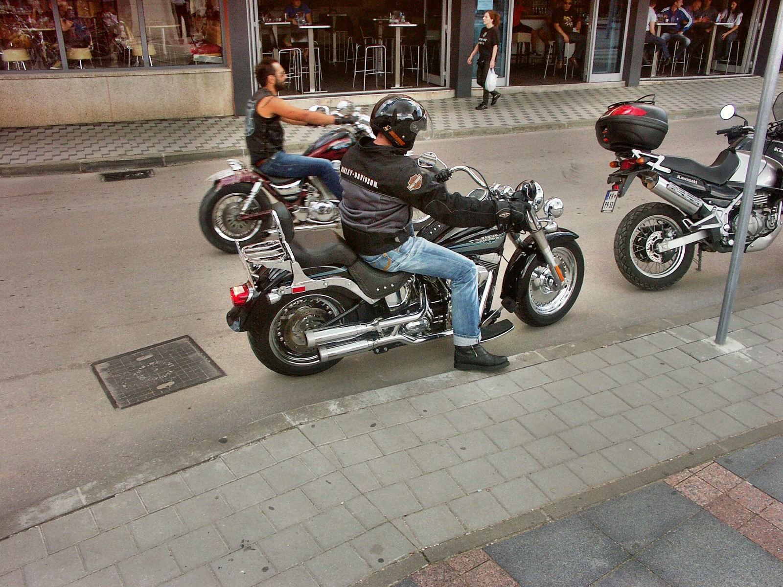 a man on a motorcycle looking at his reflection