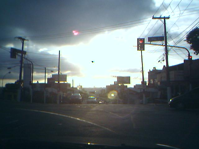 the sun is rising over the city and traffic signals