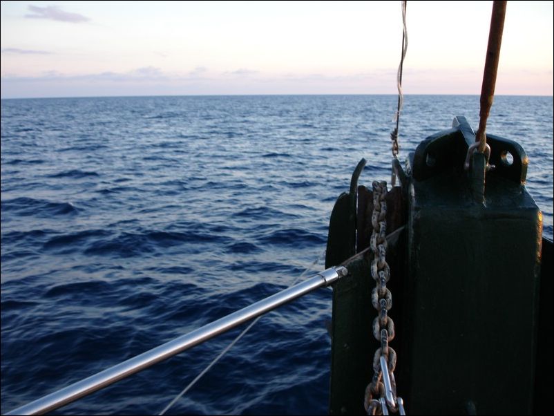 the bow end of a boat sailing across an ocean