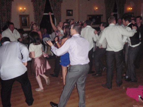 two people on dance floor in crowded room