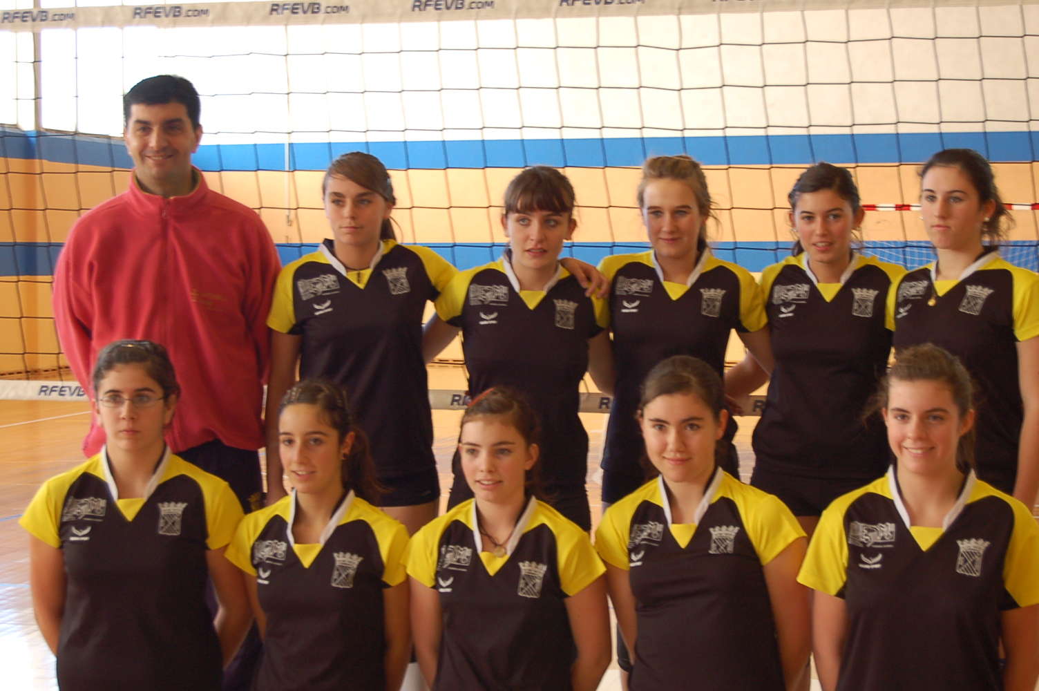 an image of female volleyball players with their coach