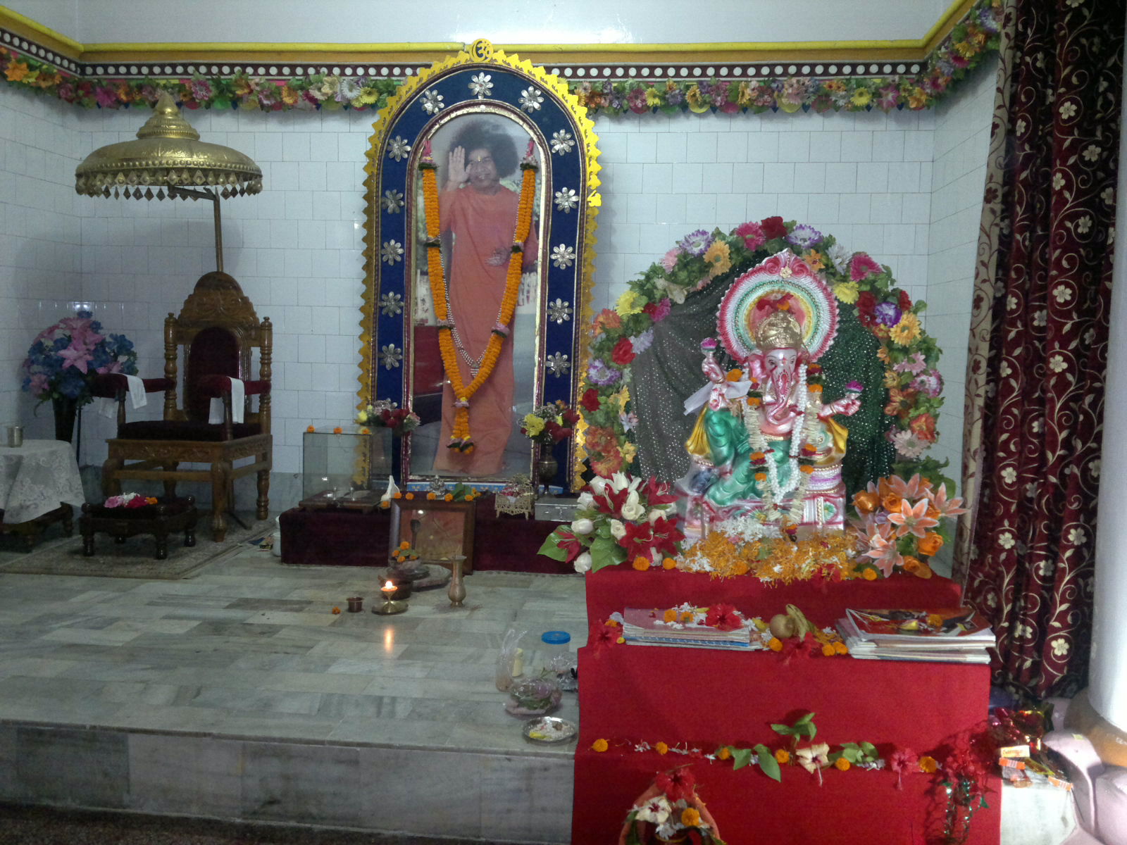 a small shrine with a person inside and lots of decorations