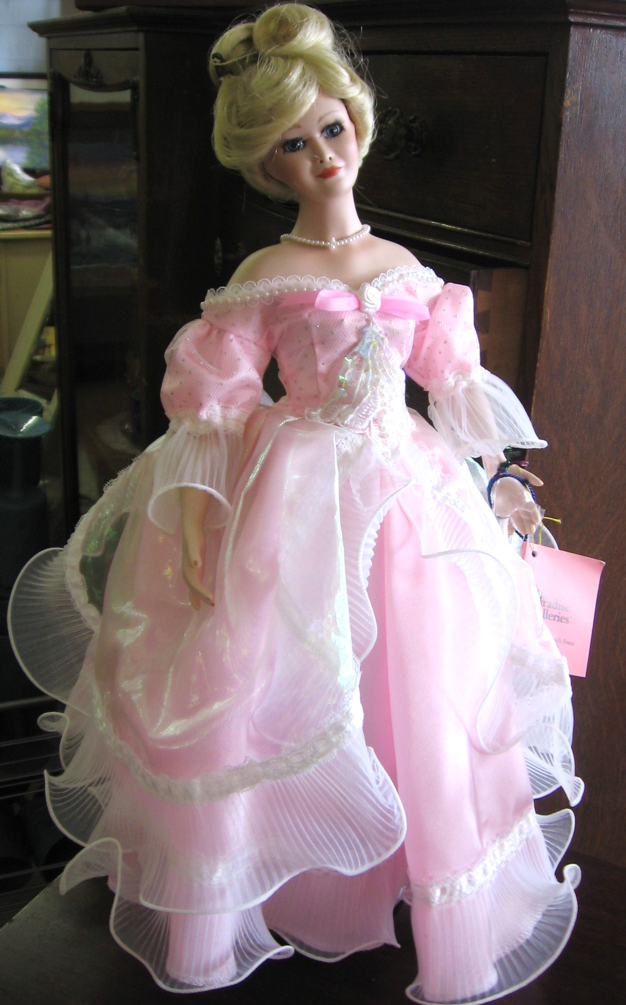 the doll is wearing a dress that matches her shoes