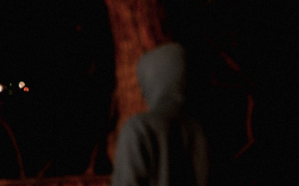 a blurry image of a man in the dark