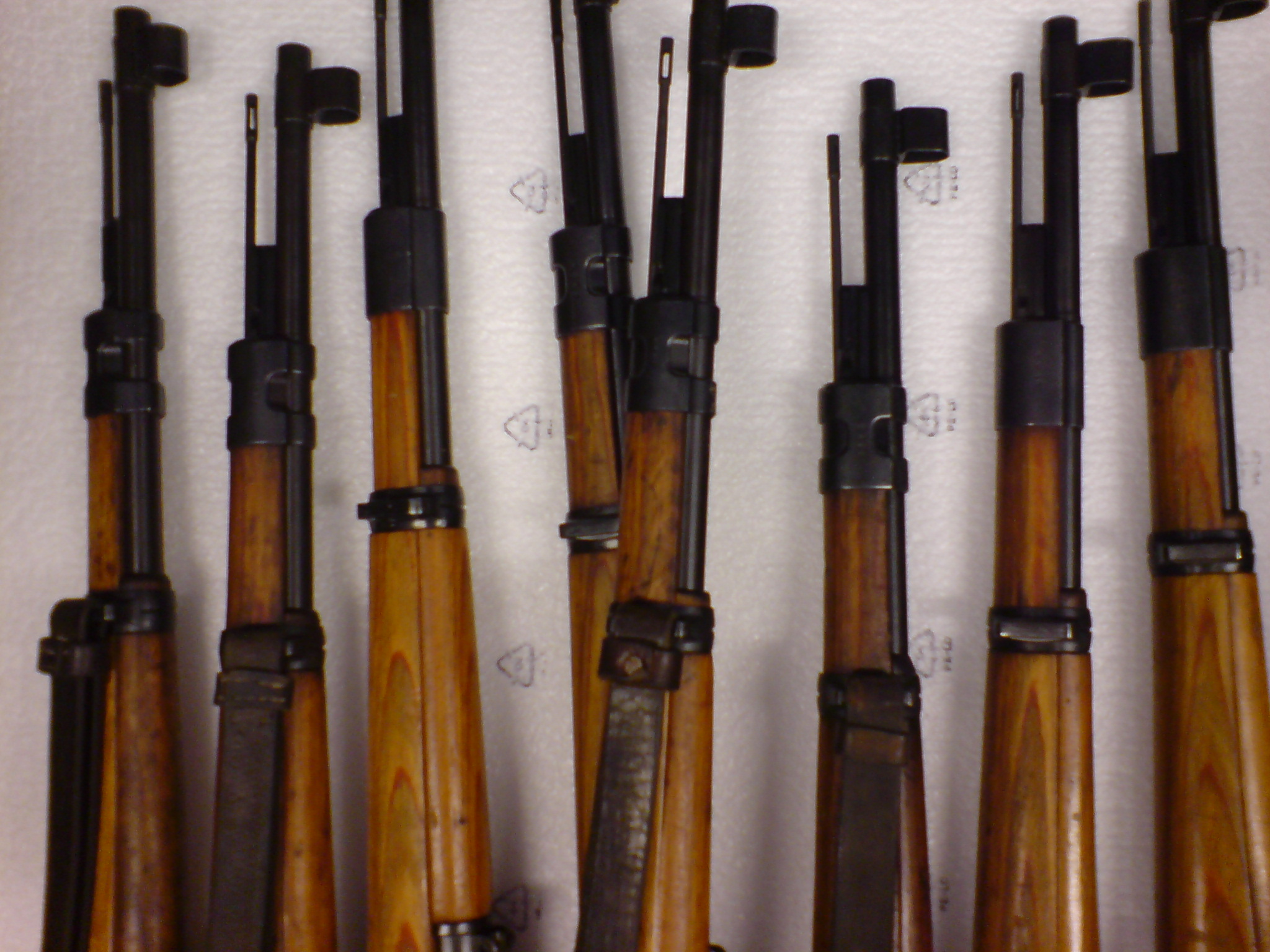 a display of old guns in various positions and sizes