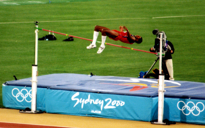 a man on a long jump performing a stunt