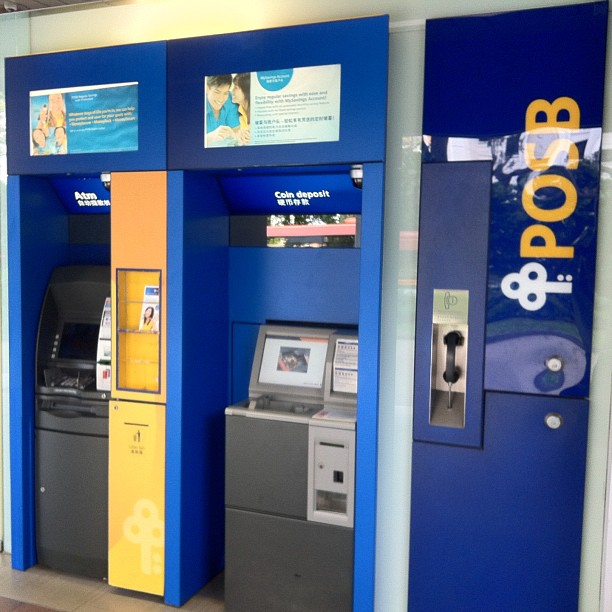 some atms and machines are displayed in a mall