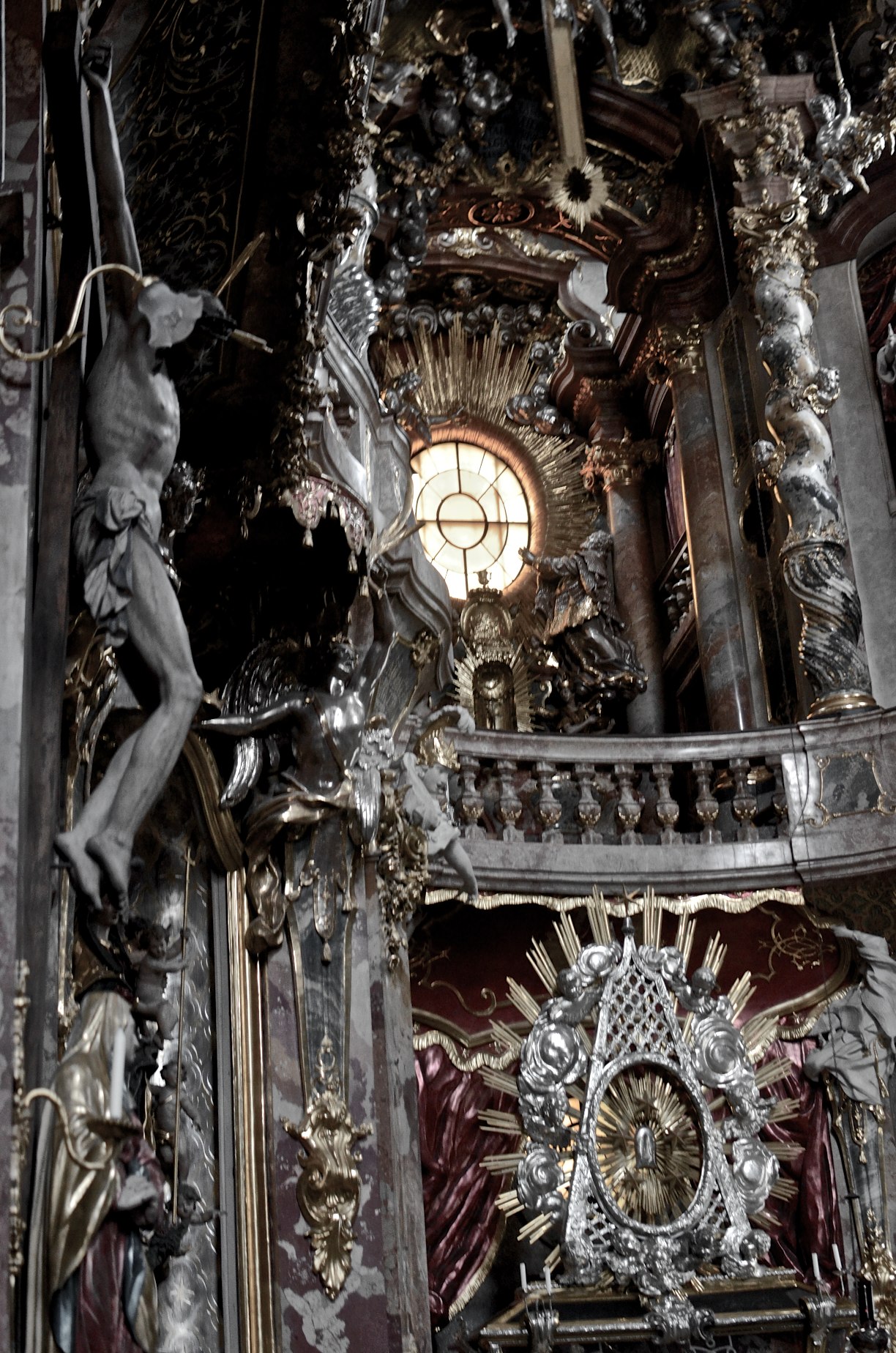 elaborate silver and gold clock hanging from the ceiling of an ornate building