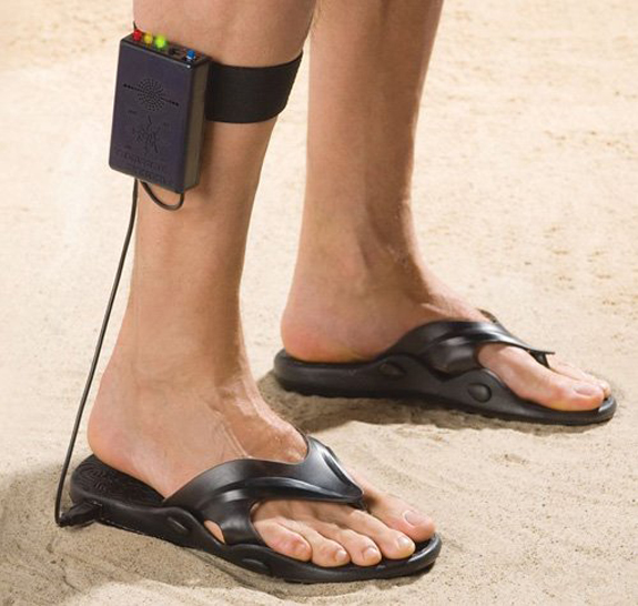 a woman with very big feet in black sandals and a headband