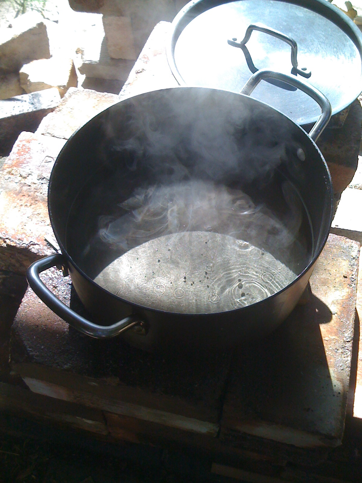 a wok is on top of fire with steam coming out