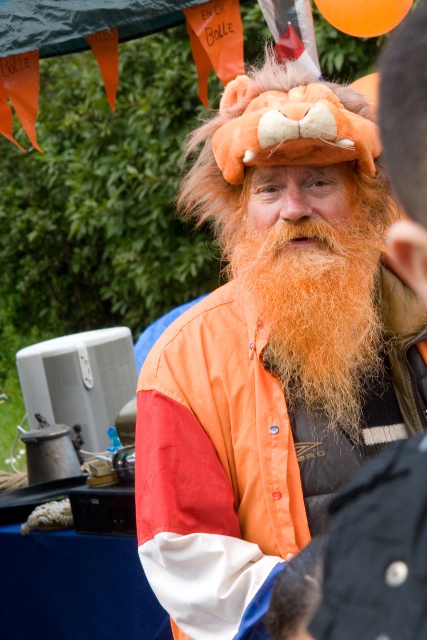 an image of a man with a long beard in an orange outfit