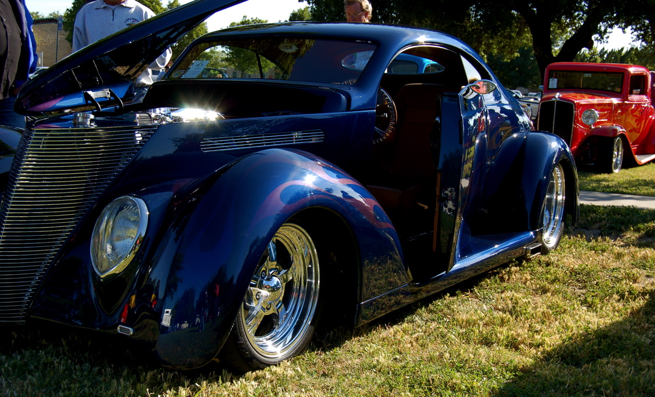 an antique vehicle parked at a car show