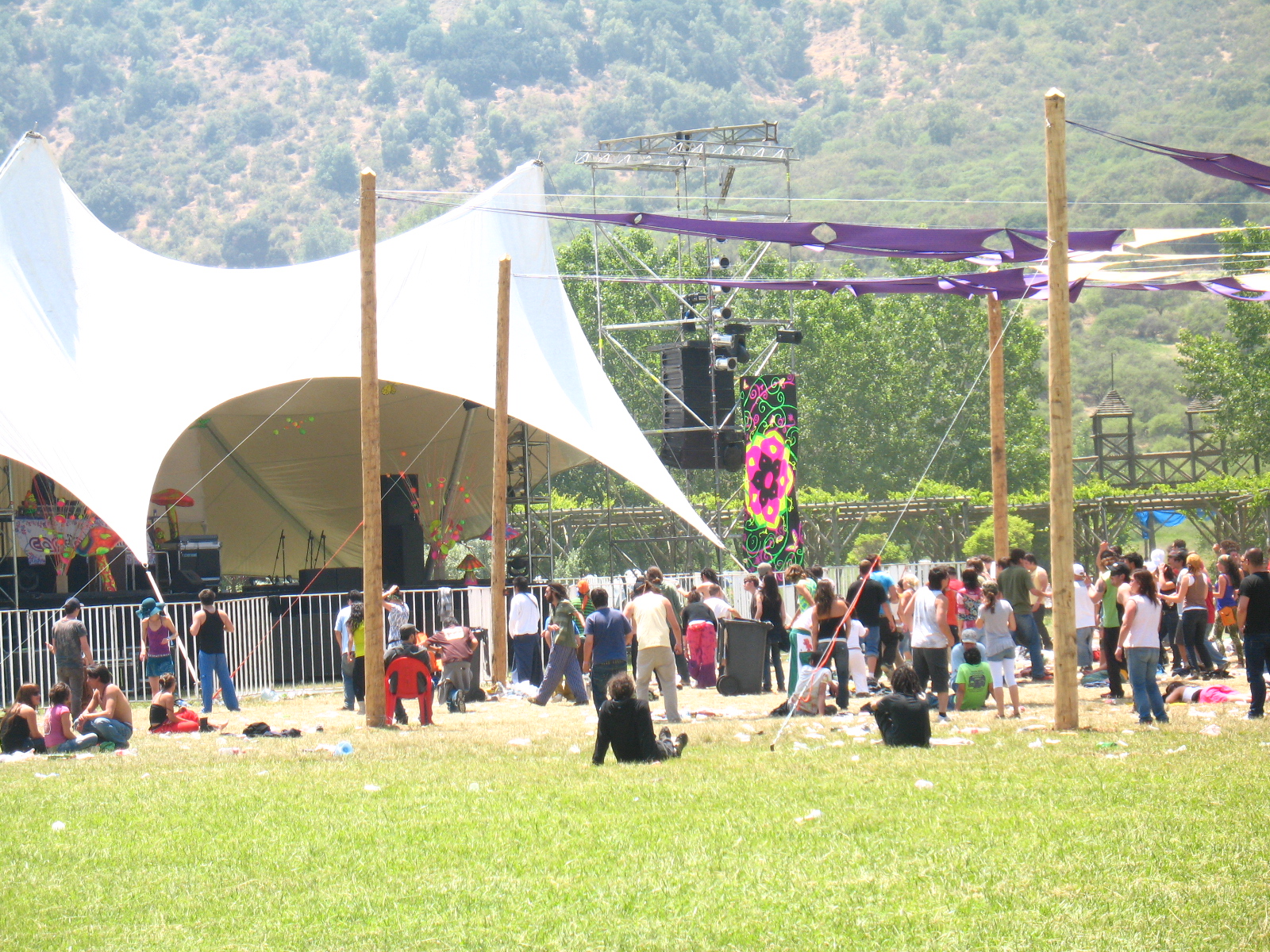 a crowd of people under a tent at an outdoor concert