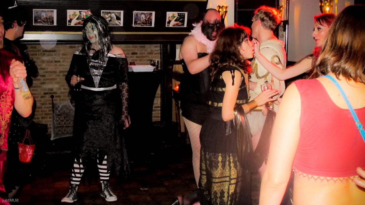 people in costume dancing and drinking at a party