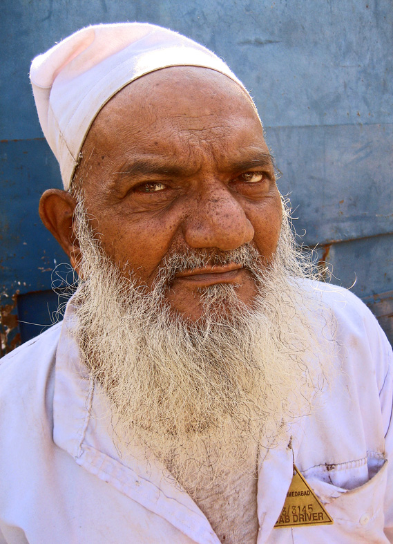 an older man with a beard and a white hat