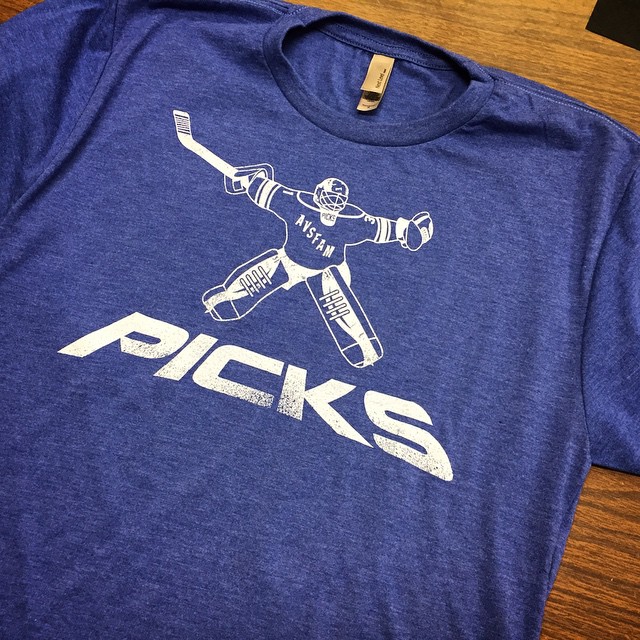 a blue shirt with a graphic of a hockey player