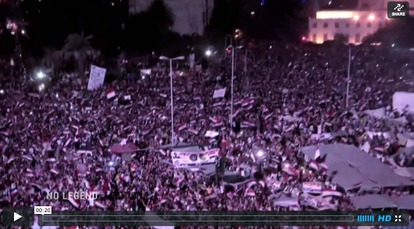 a crowd of people are standing outside at night