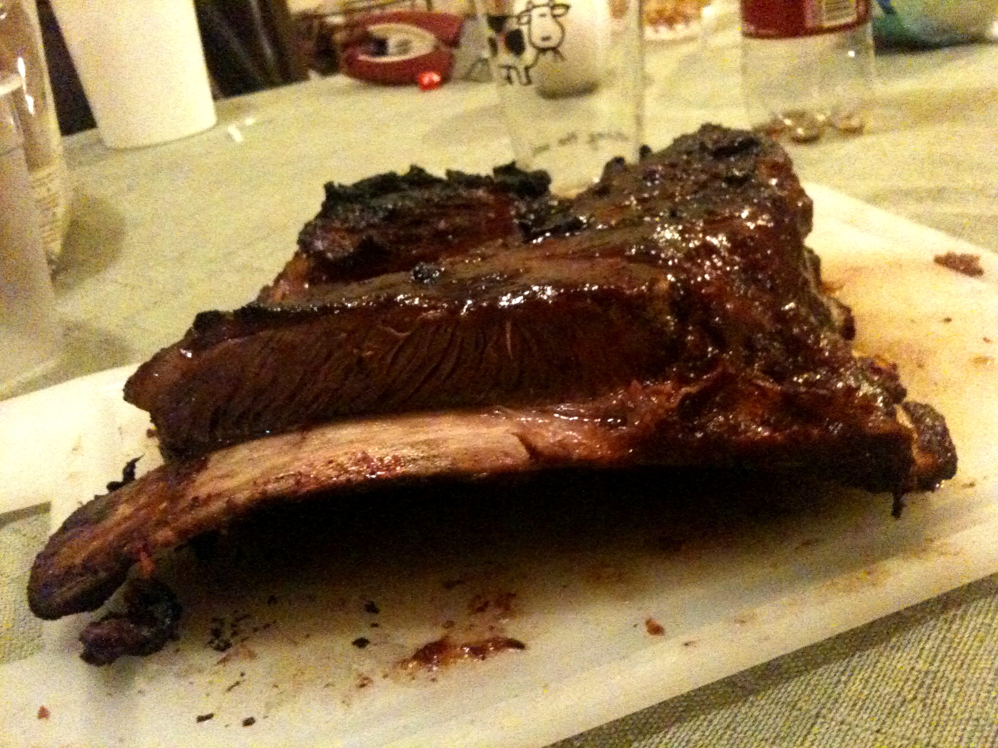 a beef and sauce sitting on top of a wooden  board