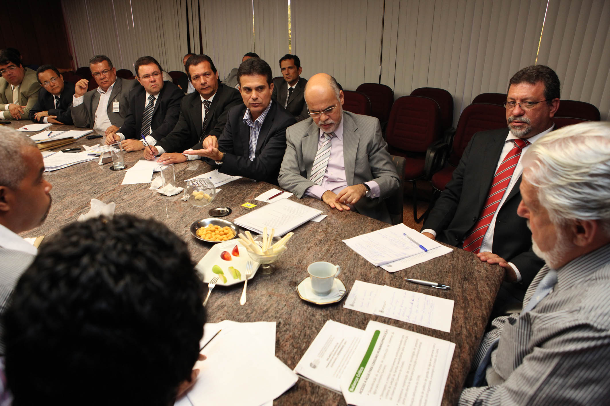 many men in business attire sitting at a table