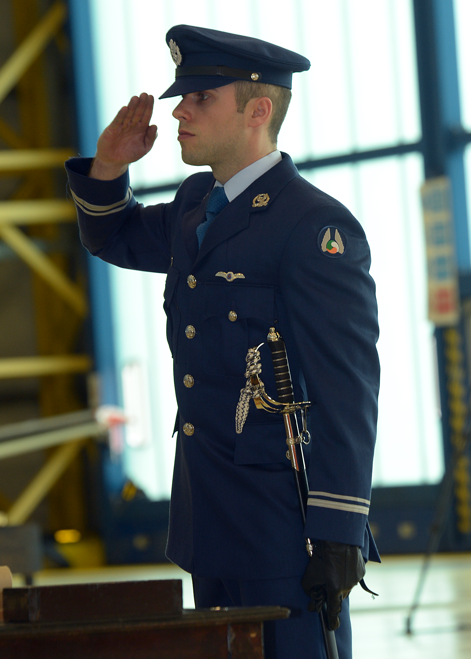 man in uniform saluting at a podium
