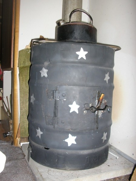 an old fashioned metal tank is on display in the garage