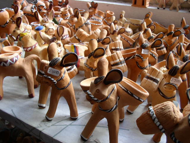 a large group of wooden carvings in the shape of animals