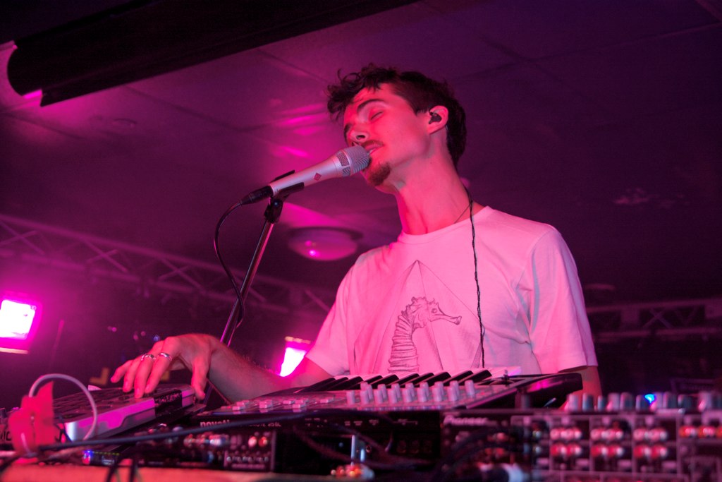 a male dj is playing a keyboard on stage