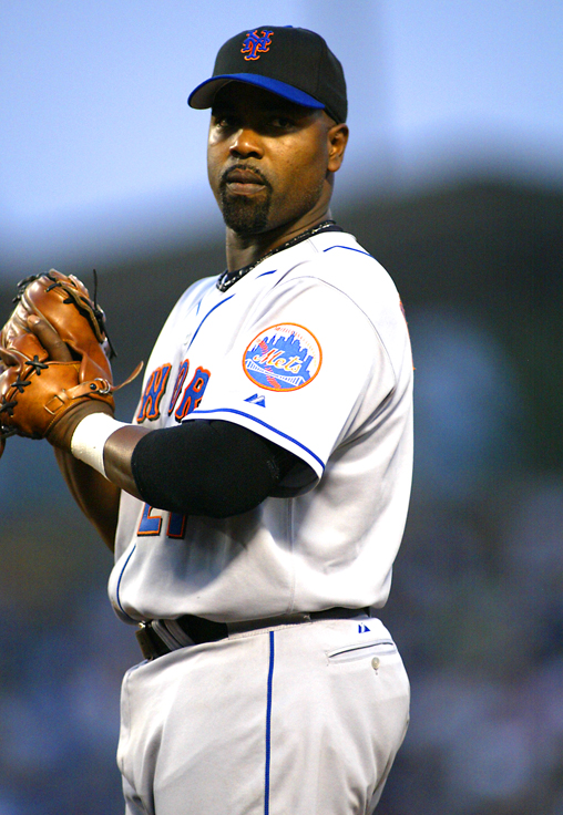 a man with a baseball glove wearing a cap