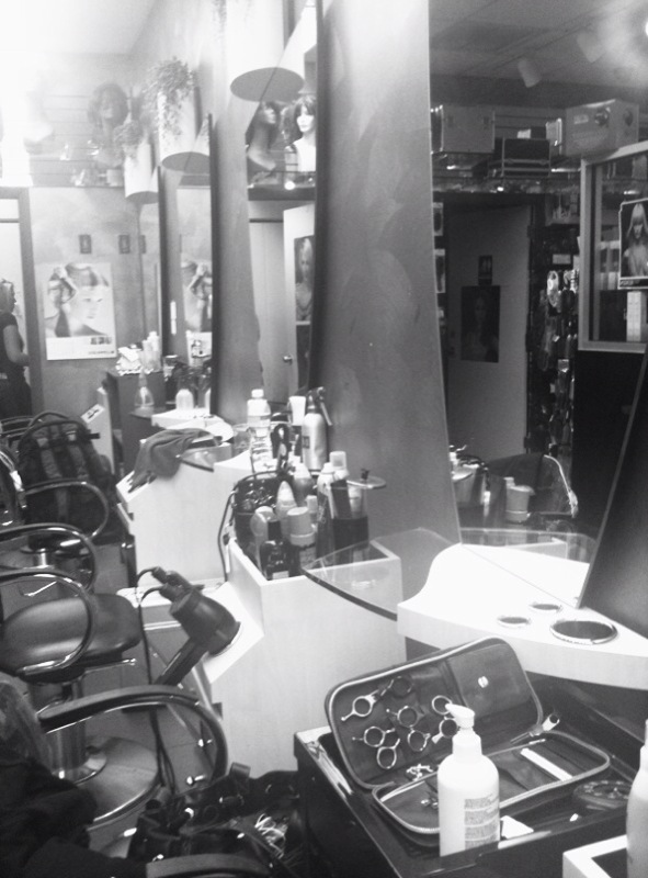 a salon filled with lots of chairs and counter tops