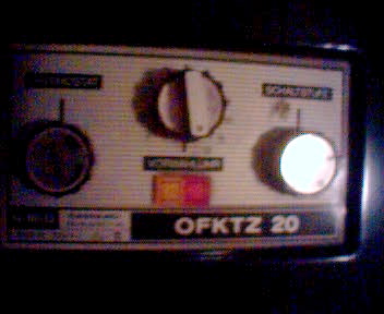 an old time radio with ons sitting on a dark table