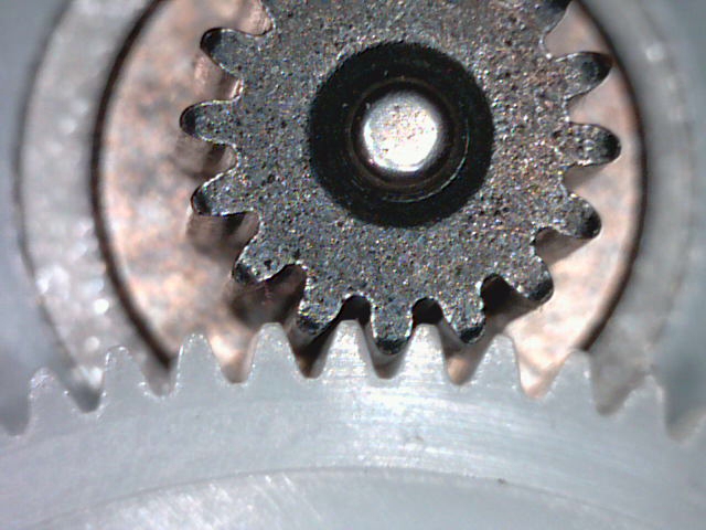 an aluminum gear wheel with metal holes in it