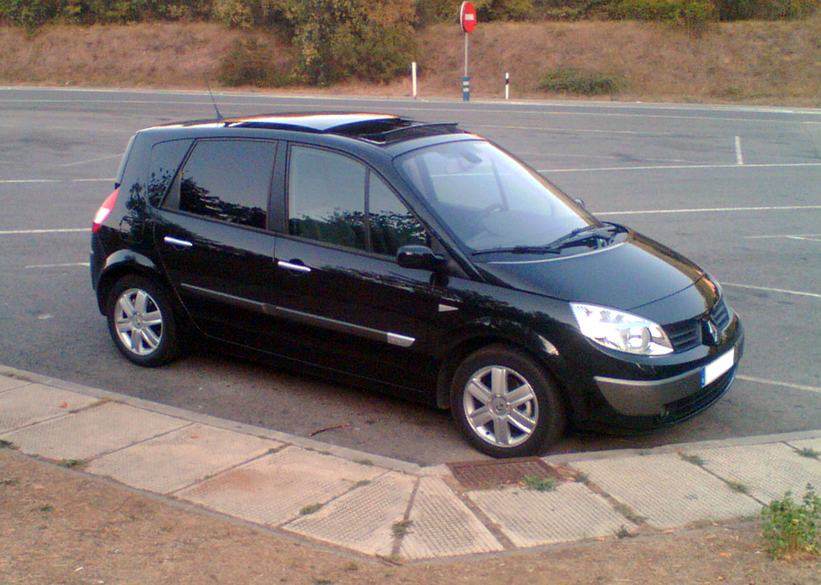 a black van is parked on the side of the road