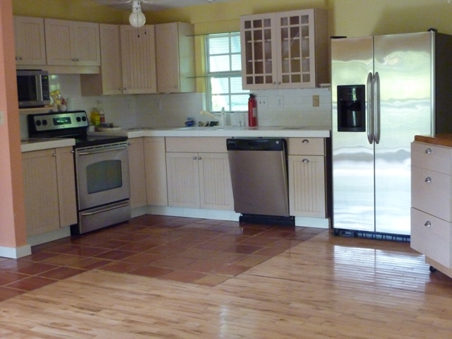 there is a new refrigerator, stove and other appliances in this kitchen