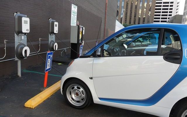 this small blue and white car is charging its own