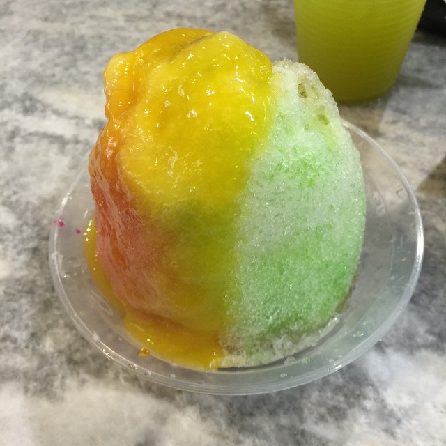 a rainbow colored dessert on a clear plate
