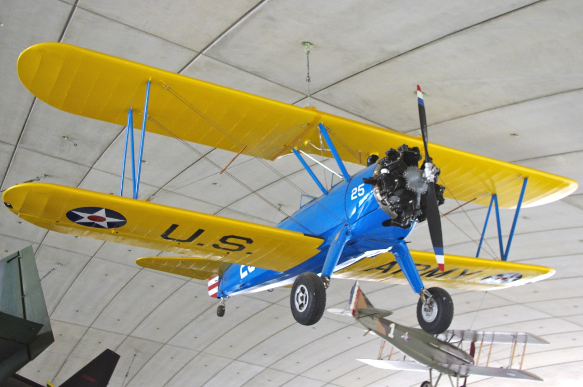 the plane is hanging from the ceiling with two wings