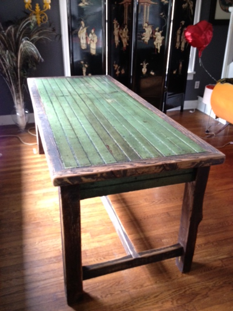 a dining table in a living room decorated with chinese and asian artwork