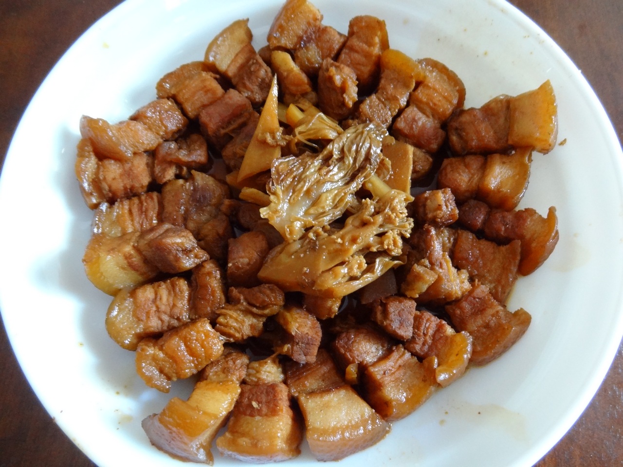 a white plate topped with meat and vegetables