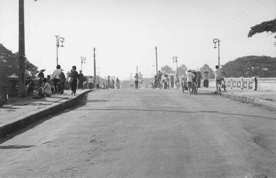 a large group of people riding bicycles down a street