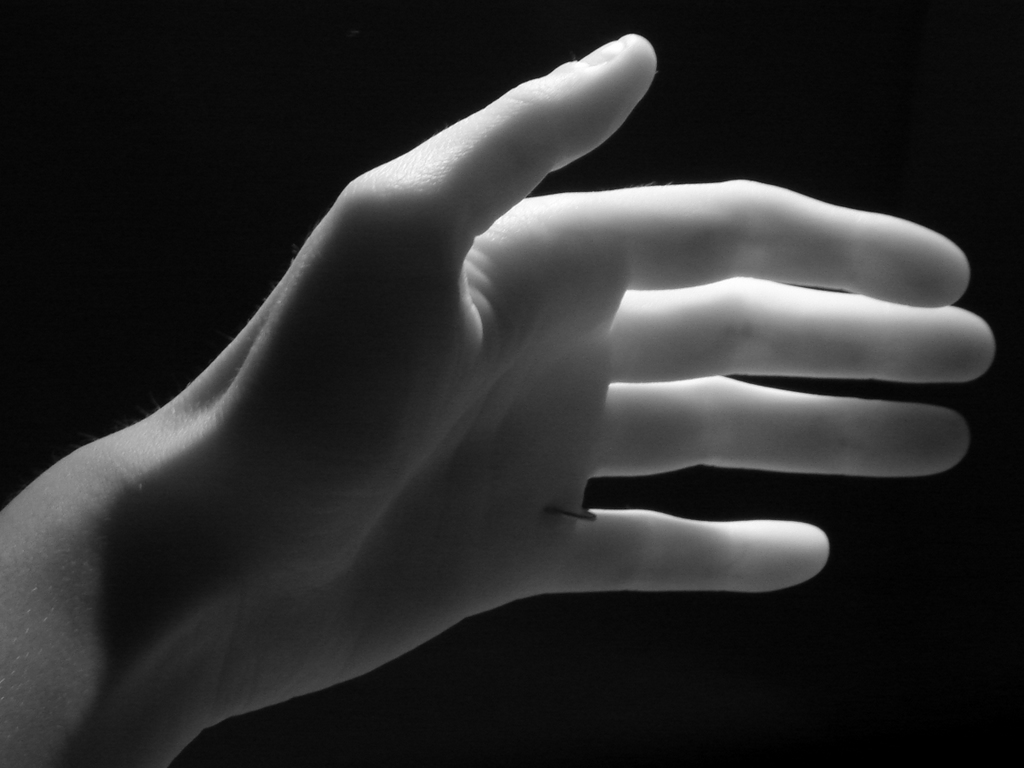 black and white pograph of hand with extended arm