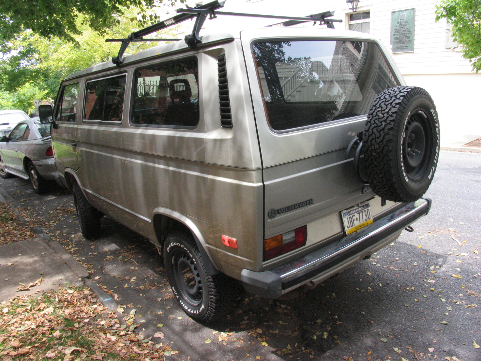 a van is parked in the driveway with one tire stuck in the back window