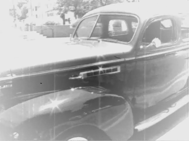 a man driving in a vintage truck on the road