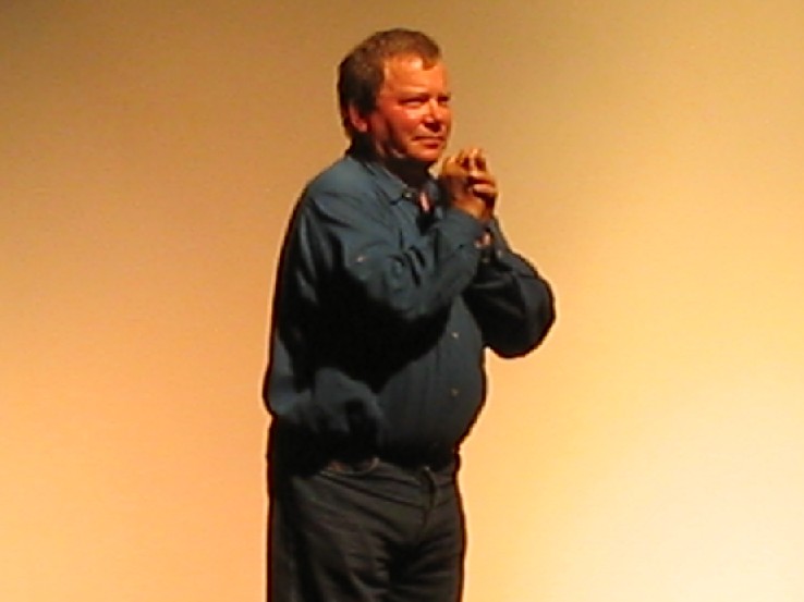 a man in blue shirt holding soing in his hand