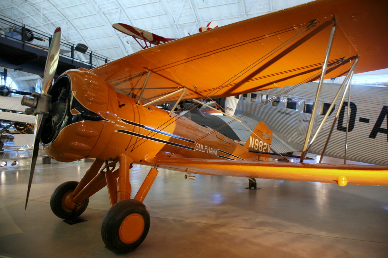 an orange airplane is on display in a hangar